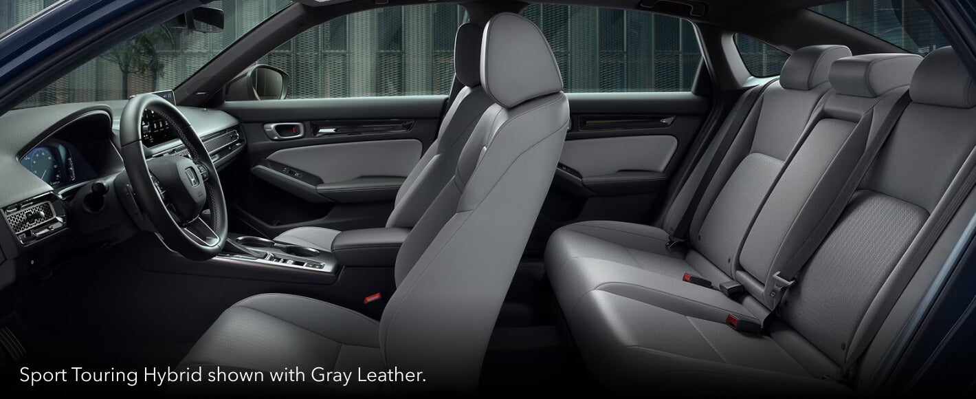 Cross-section shot showing the interior space of the 2026 Honda Civic Sport Touring Hybrid with Gray Leather.
