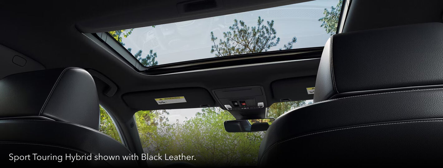 Interior low angle shot showing a 2026 Honda civic Sport Touring Hybrid moonroof and Black Leather seats.